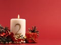 White candle with the number two burns, Advent background Royalty Free Stock Photo