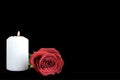 White candle and red rose isolated on black Royalty Free Stock Photo
