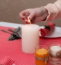 The white candle stands on the table. Festive composition with Lighted candles. Christmas table decoration. A beautiful table. Royalty Free Stock Photo