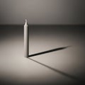 White candle stands upright, casting a long shadow on a plain, Royalty Free Stock Photo