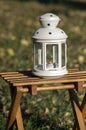 White candlelight lantern in the garden, autumn season