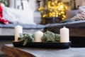 White candles and pine branches in Christmas home decor Royalty Free Stock Photo