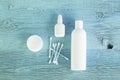 White cans and cotton pads with cotton swabs on a blue wooden background. Hygiene products.