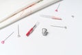 White canvas background with sewing tools and colorful threads. Mockup for hobby. Embroidery concept.