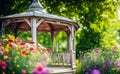 White canvas gazebo with garden flowers in a summer green lawn