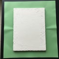 White canvas with a rough, uneven surface is placed on a smooth green Royalty Free Stock Photo