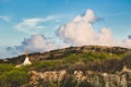 White canvas teepee camped in a field under a cloudy blue sky Royalty Free Stock Photo