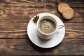 White cap of coffee and anise on a small plate with two cakes.   Flat Lay with no people Royalty Free Stock Photo