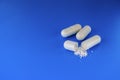 White capsules on a blue background3 white capsules on a blue background Royalty Free Stock Photo