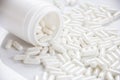 White capsules of pills are getting out of the bottle Royalty Free Stock Photo