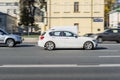 White car BMW 1 series F21 fast speed drive on city road Royalty Free Stock Photo