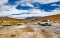 White car in Bolivian desert Royalty Free Stock Photo