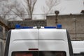 A white car brand gazel models of next ambulance and resuscitation in Russia with flashing blue beacons shot from behind against Royalty Free Stock Photo