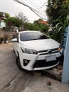 White car crashed accident on garden and blue cement fence of residence Royalty Free Stock Photo