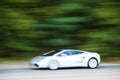 White car driving fast on country road Royalty Free Stock Photo