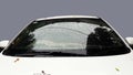 white car front view rain drops on glass closeup image Royalty Free Stock Photo