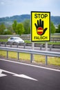 White car on the highway in the austrian countryside with the STOP/ FALSCH stop / false sign to warn the drivers Royalty Free Stock Photo