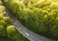 White Car on Highway road in summer time nature from air in the forest. View from a drone. Aerial view Royalty Free Stock Photo