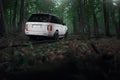 White car Land Rover Range Rover standing in forest road at daytime Royalty Free Stock Photo