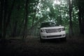 White car Land Rover Range Rover standing in forest road at daytime Royalty Free Stock Photo