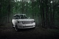 White car Land Rover Range Rover standing in forest road at daytime Royalty Free Stock Photo