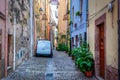 White car parked in a narrow alley in old town Bosa Royalty Free Stock Photo