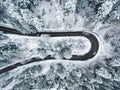 White car passing on an extreme winding road in wintertime Royalty Free Stock Photo