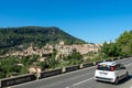White car on the road that reaches the pretty town of Valldemossa (Mallorca, Spain) Royalty Free Stock Photo