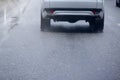 White car running on the road on rainy.