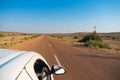 White car running through empty high road or national high way passing through the desert. Distant horizon, Hot summer at Thar Royalty Free Stock Photo