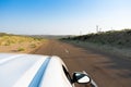 White car, running through empty high road or national high way passing through the desert. Distant horizon, Hot summer at Thar Royalty Free Stock Photo