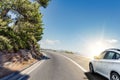 White car rushing along a high-speed highway.