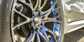 White car with silver tire rim and blue bolts Royalty Free Stock Photo