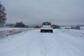 White car on snowy country lane Royalty Free Stock Photo