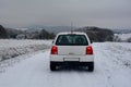 White car on snowy country lane Royalty Free Stock Photo