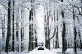 White car on snowy country road Royalty Free Stock Photo