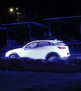 White Car On A Snowy Roadside At WInter Night