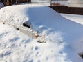 White car under snowdrift in parking lot Royalty Free Stock Photo