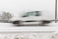 White car, van driving fast on the road in winter landscape, with snowy weather. Motion blur Royalty Free Stock Photo