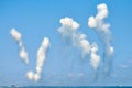 White carbon fiber clouds in blue sky hiding naval destroyers from anti-ship missiles, military show Royalty Free Stock Photo