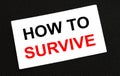 White card on the black background with text How To Survive Royalty Free Stock Photo