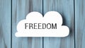 White card in cloud shape with text FREEDOM on stylish Royalty Free Stock Photo
