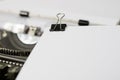 A white card with a paper clip on a typewriter. Paper sheets wit Royalty Free Stock Photo