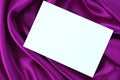 White card on purple satin