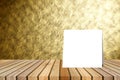 White card put on table and blurred abstract gold wall texture background. product display template. Business presentation.