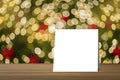 White card put on table and blurred bokeh out of focus in christmas night light background. product display template.
