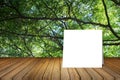 White card put on wooden desk or wooden floor on blurred green tree nature background.use for present or mock up your product. Royalty Free Stock Photo