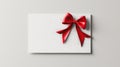A white card with a red bow on it. card is blank and ready to be written on. Blank white gift voucher with red ribbon bow or empty Royalty Free Stock Photo