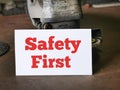 White card written SAFETY FIRST on tools table. Royalty Free Stock Photo