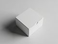 A white cardboard box with a closed lid on a plain gray background Royalty Free Stock Photo